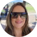 HOA attorney / HOA law A woman with long brown hair and a warm smile, wearing sunglasses and a casual outfit